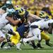 Michigan defense tackles Michigan State running back Le'Veon Bell in the first half on Saturday. Michigan won 12-10. Daniel Brenner I AnnArbor.com